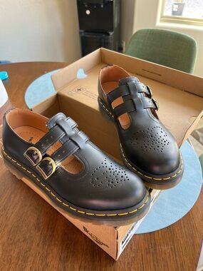 Dr. Martens Woman’s so Black Leather T-Bar Shoes with Yellow Stitching